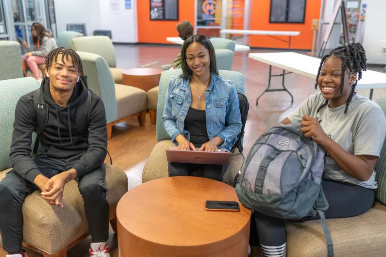 Three students gathered in the Student Center