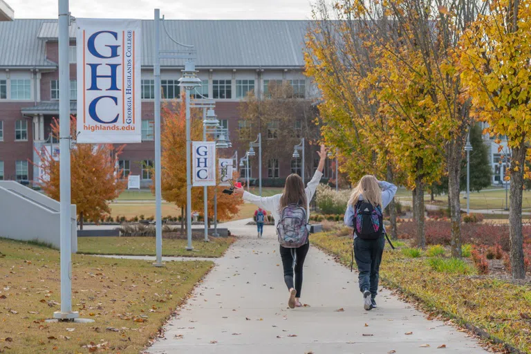 Two students walk toward Building A