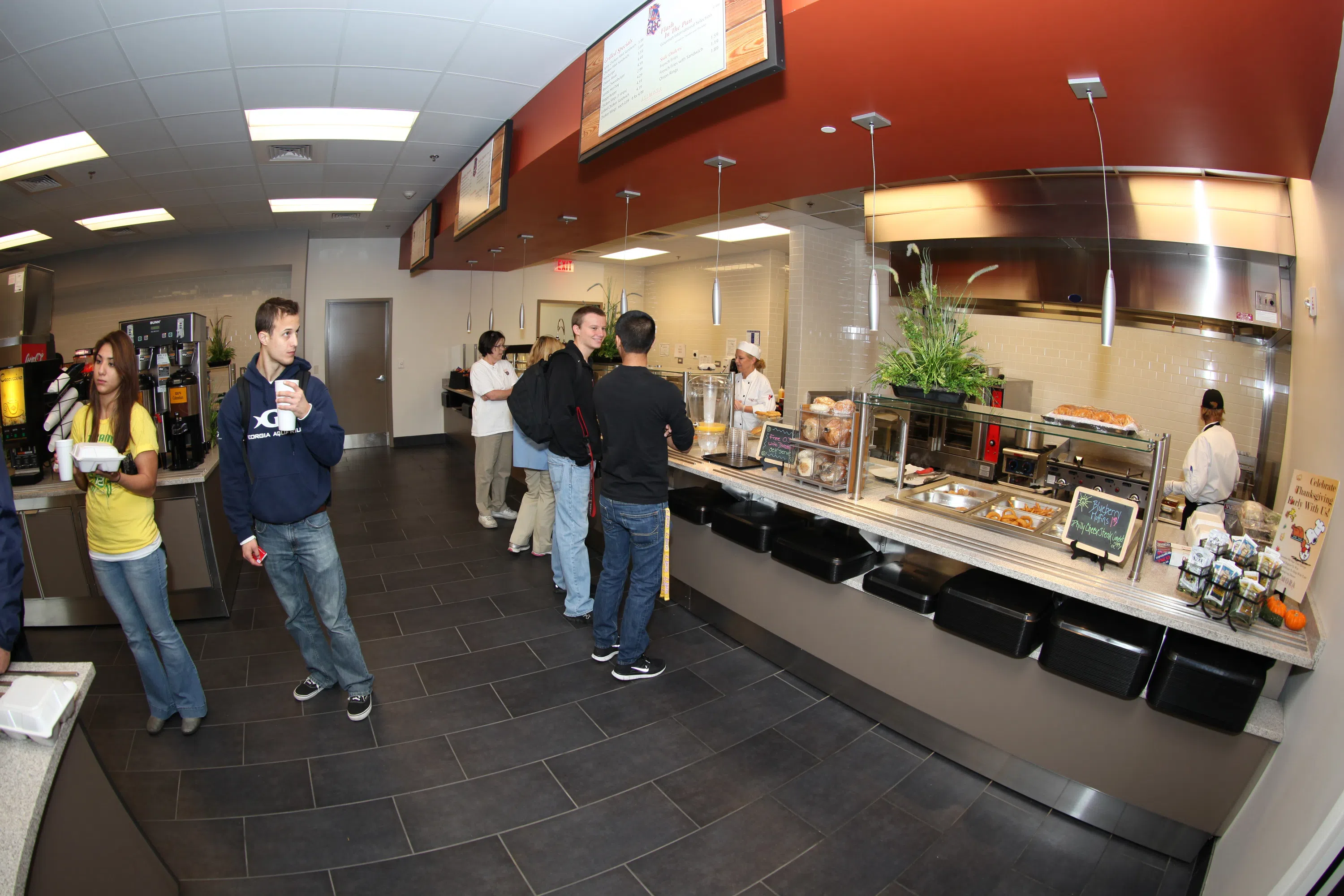 Students grab food from the hot station at Charge Café