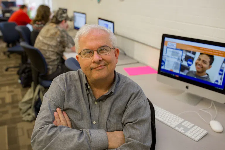 Person in the Tutorial Center looks up and smiles at the camera