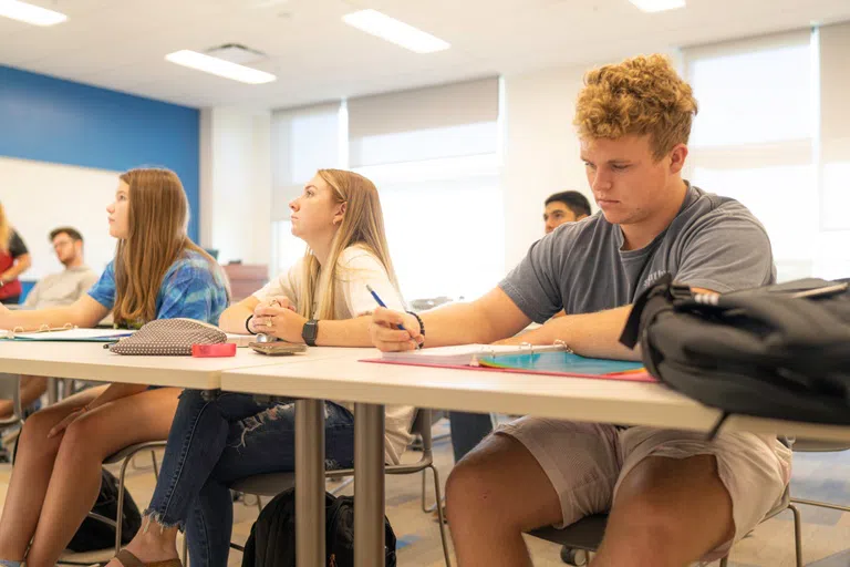 Student take notes in the second floor classroom 