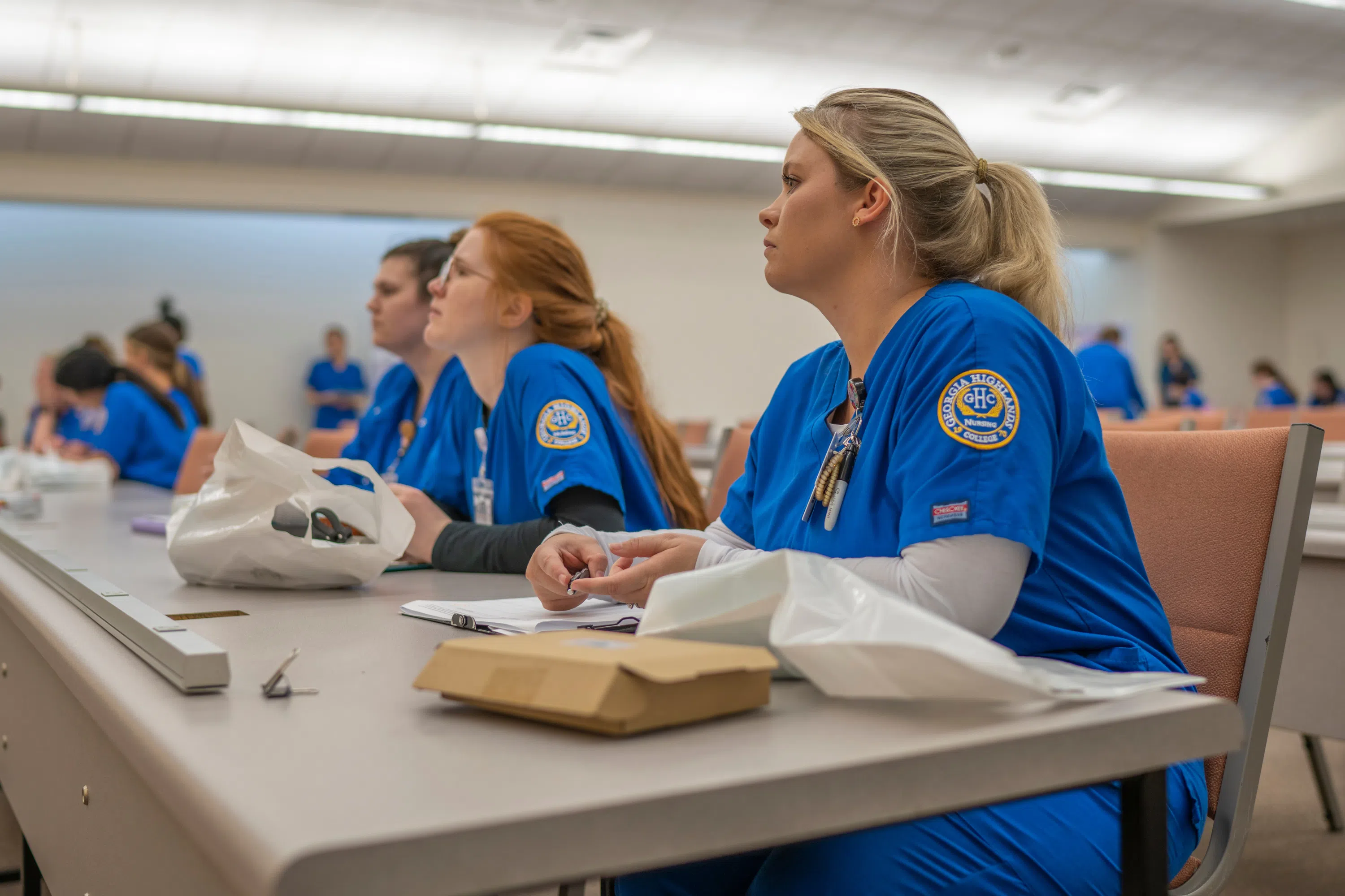 Nursing students listening to a professor during class