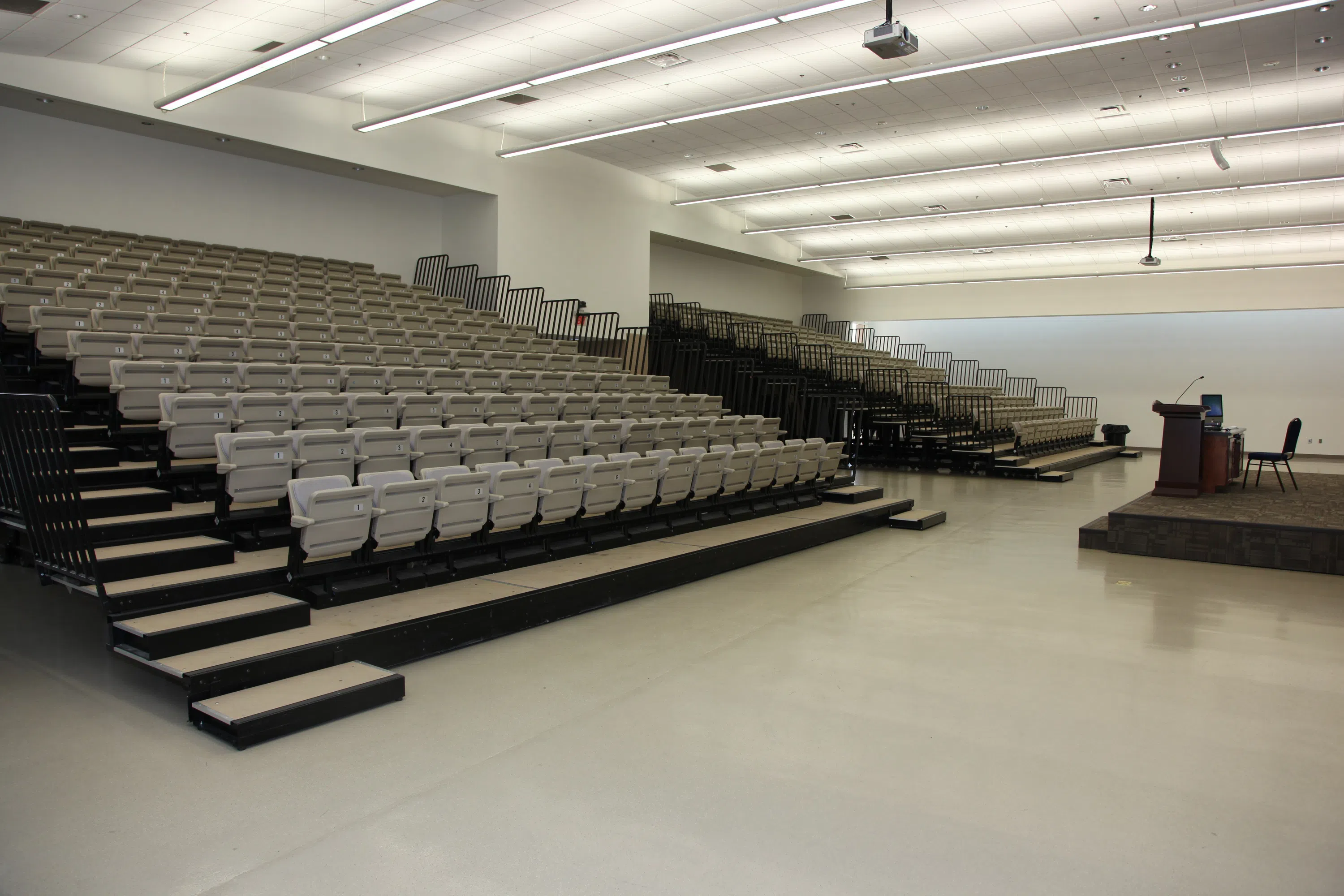 Auditorium with stadium-style seating and podium in the front