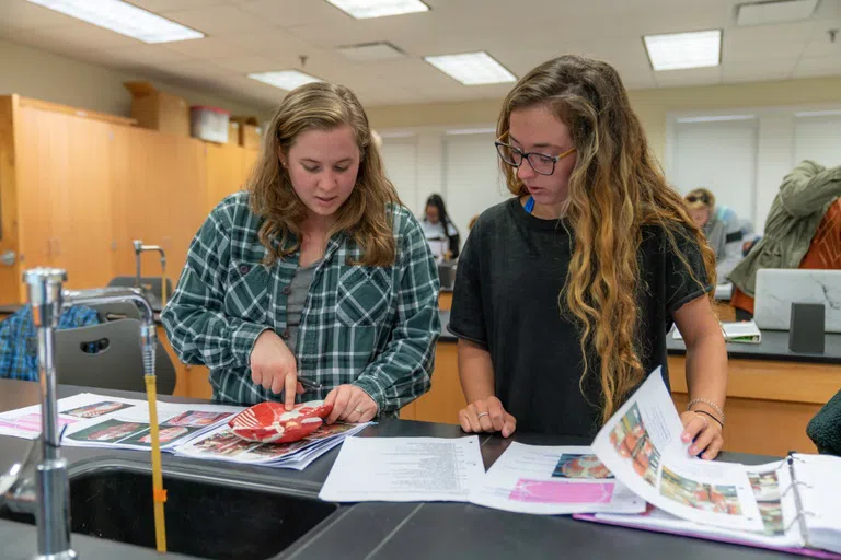 Two female student study together in a Bagby building lab