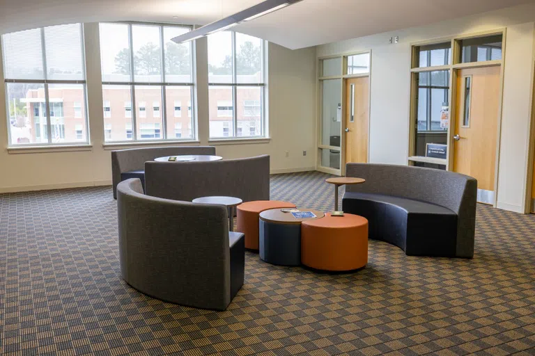 Common area with couches and round coffee tables 