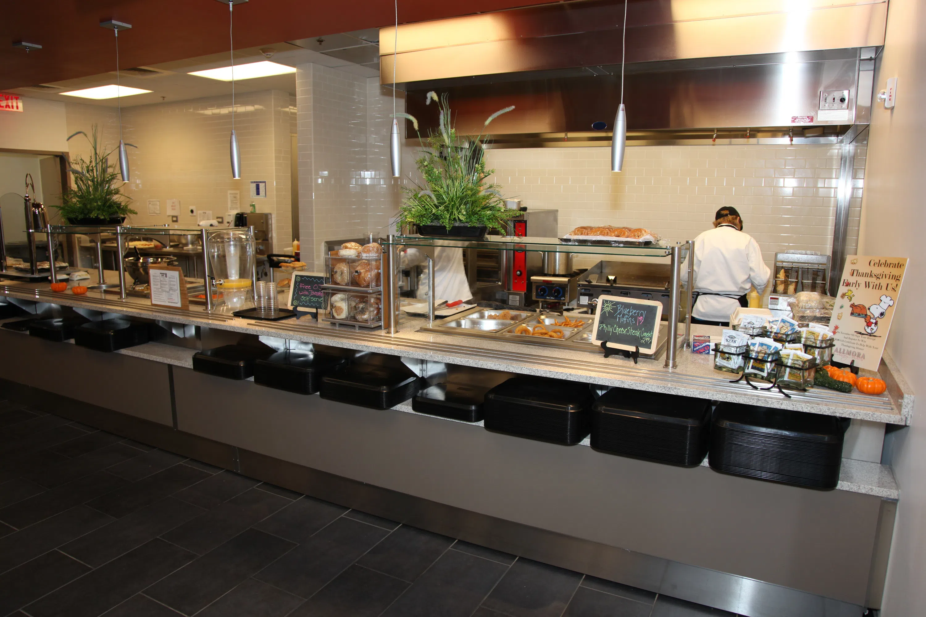 Hot bar at the Charger Café. Chef works in the background, preparing food. 