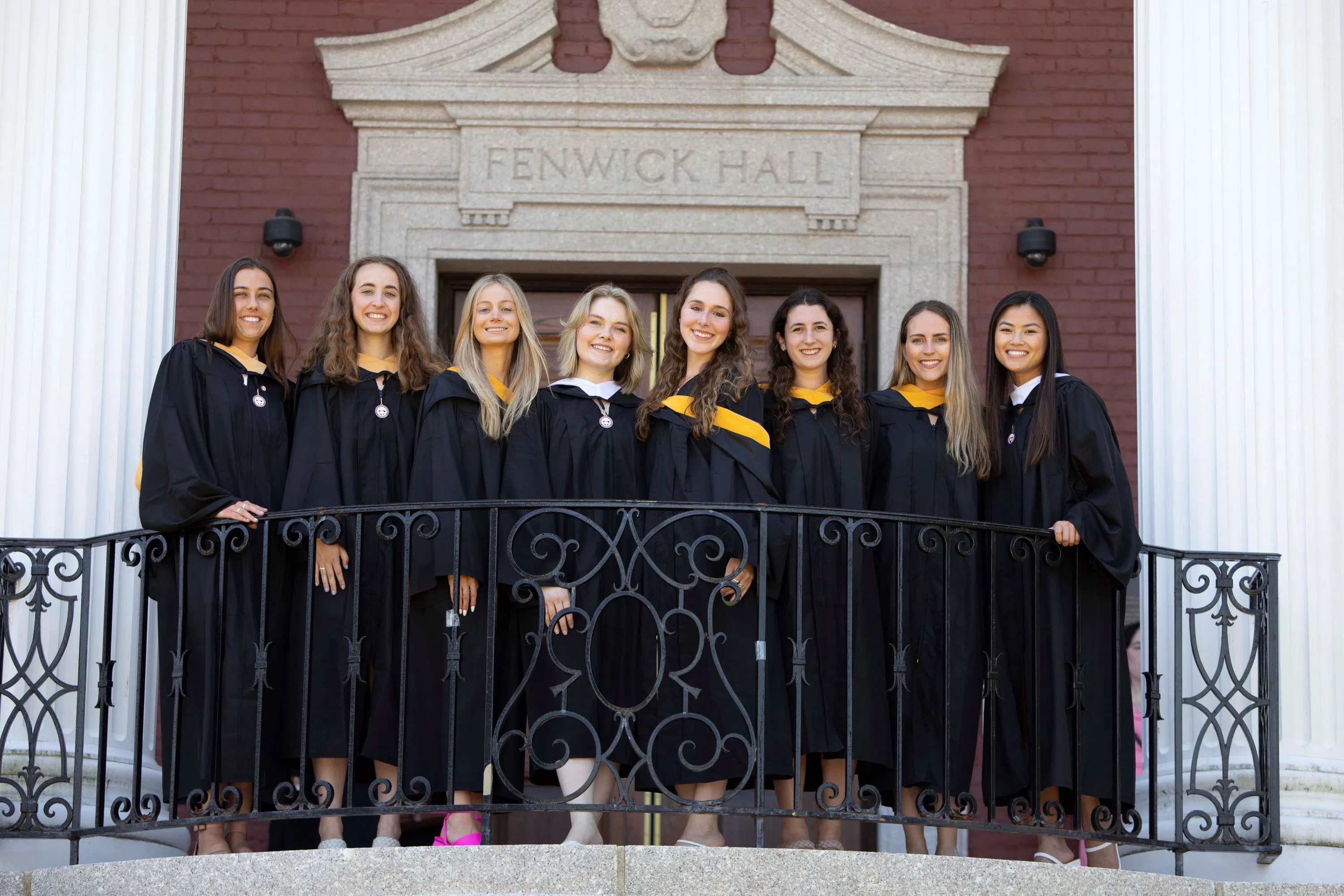 Graduating students standing on the Fenwick Porch.