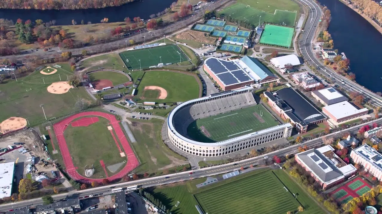 Aerial view of a football stadium, track field, baseball and softball fields