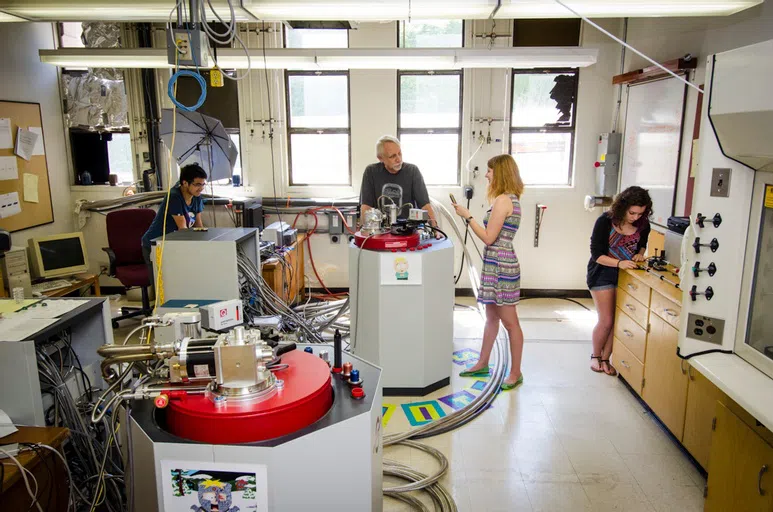 Students and professor in physics lab