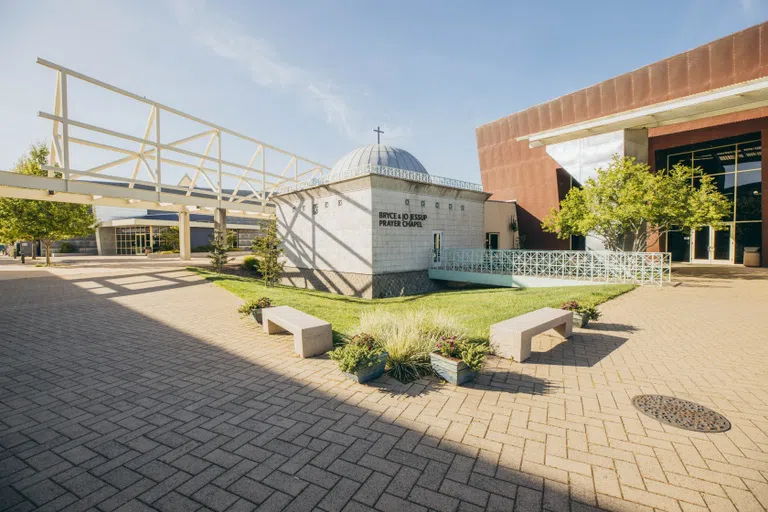 Prayer Chapel exterior building with grass patio and benches