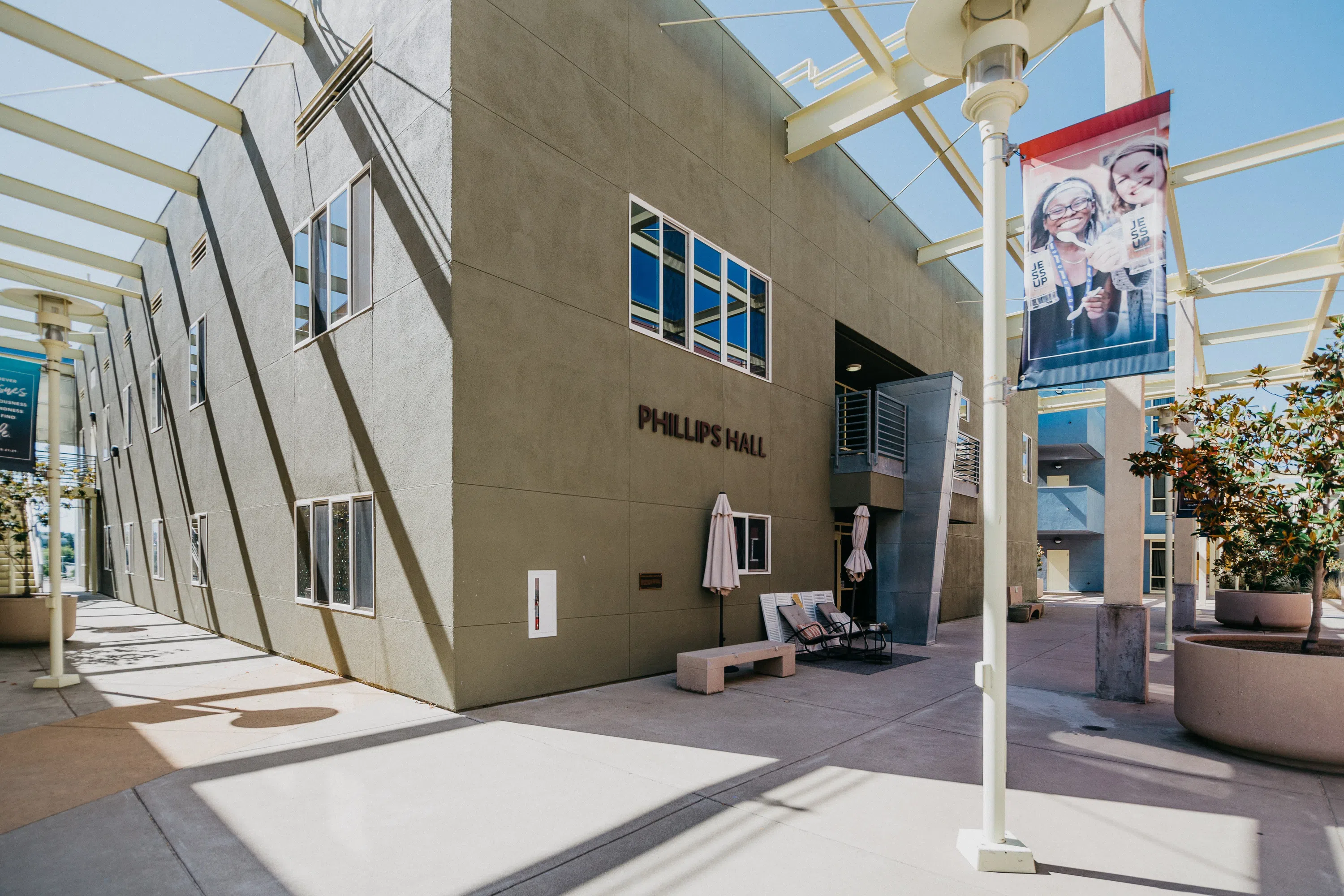 Exterior of Phillips Hall with patio and seating area