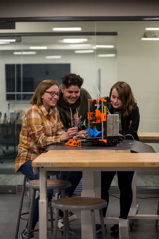 students creating with a 3D printer