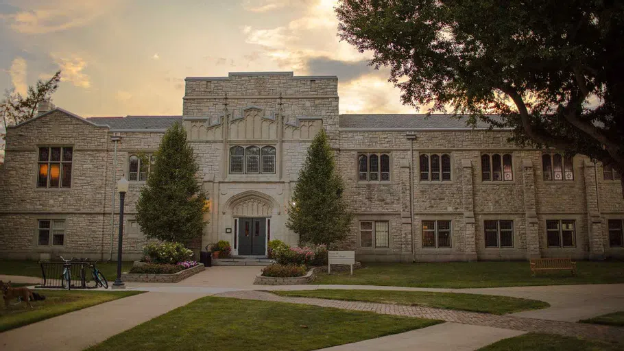 The sun sets behind Knox College's Seymour Library.