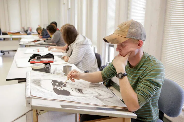 Students drawing in art class