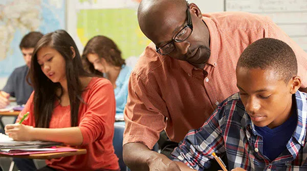 Professor assists student with classwork.