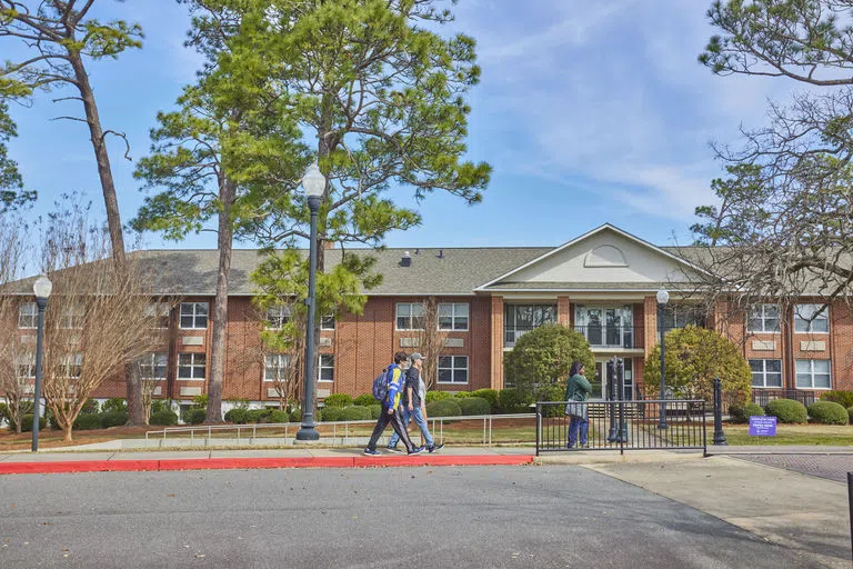 Students walking in front Grace Hall