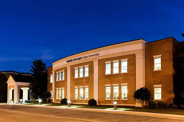 The Library Building is illuminated in the evening.