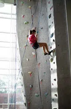 Student climbs the rock wall.