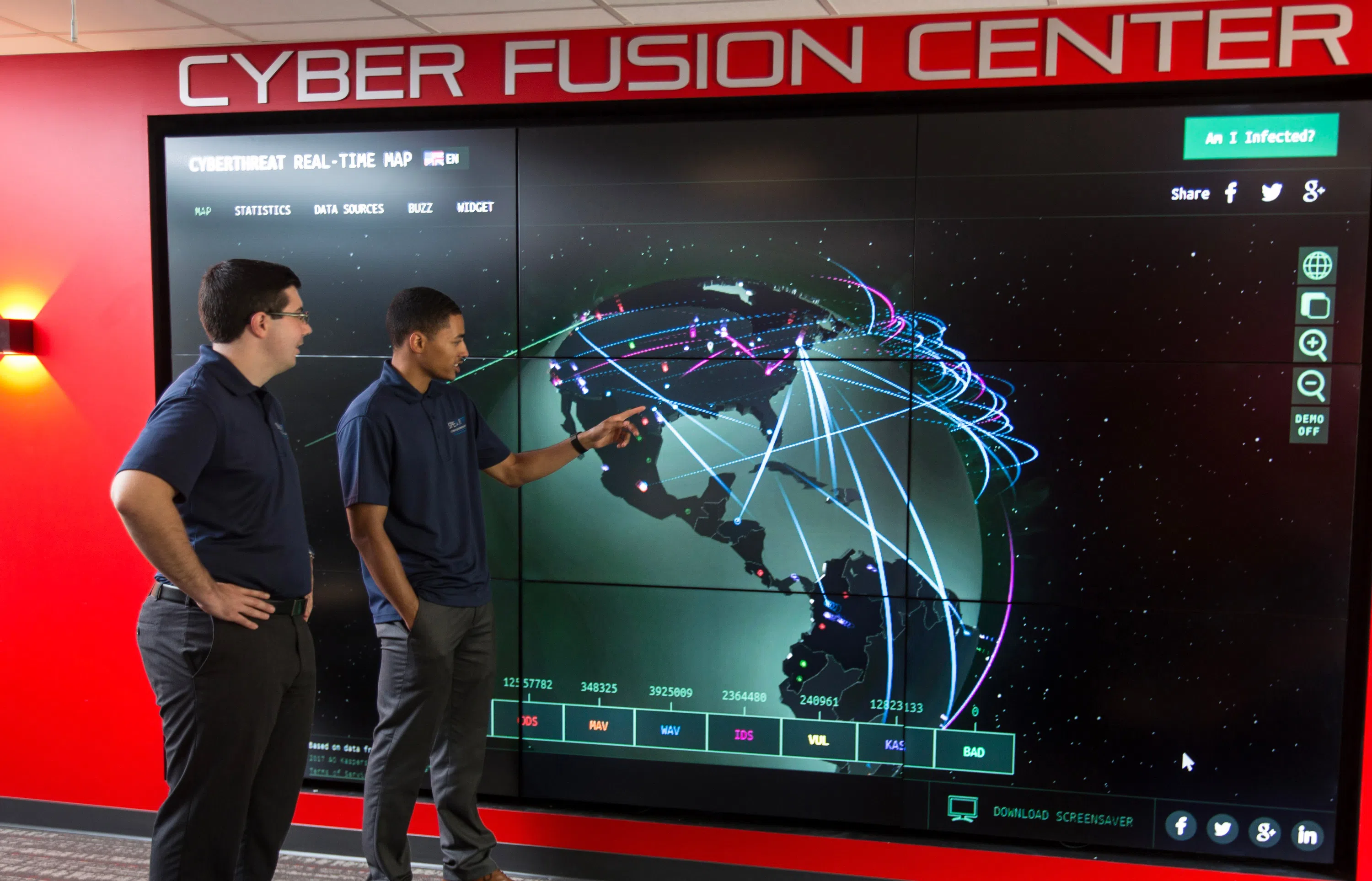 Students check out a wall monitoring global cyber attacks in the Cyber Fusion Center (CFC). 