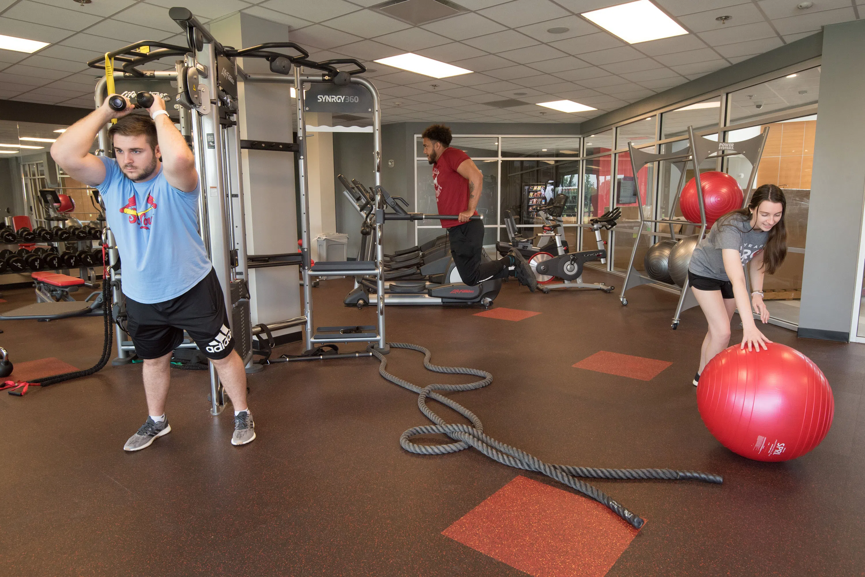 Students use equipment in the fitness center located on the bottom floor of Saints Hall.