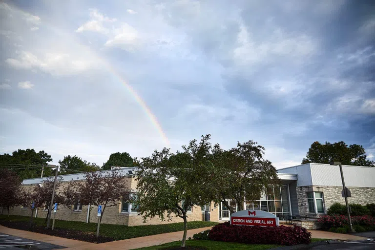 The exterior of the DVA building with a rainbow in the distance. 