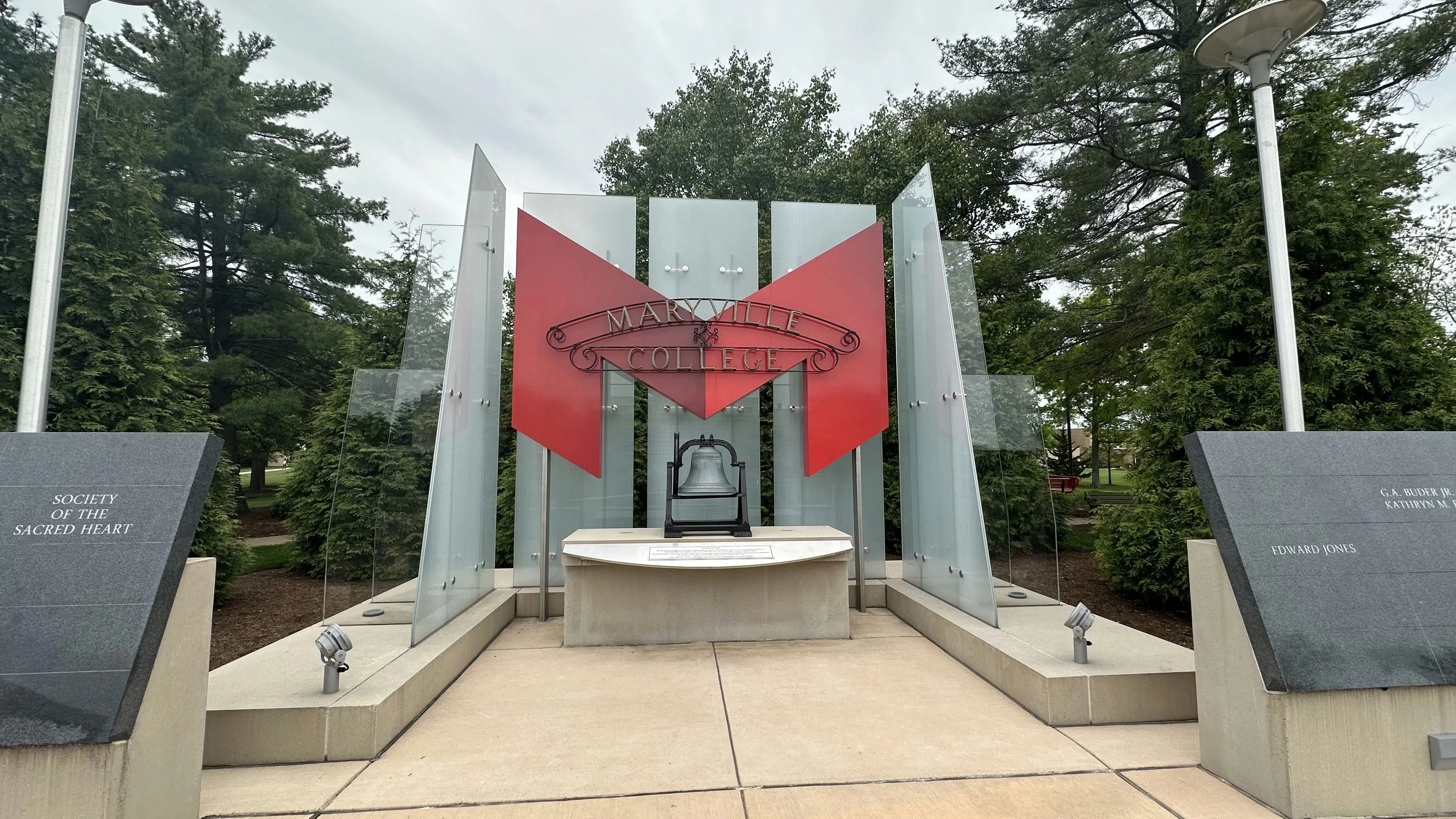 The original "Maryville College" sign sits in front of the Big Red "M". In front of this is the Maryville Bell. 