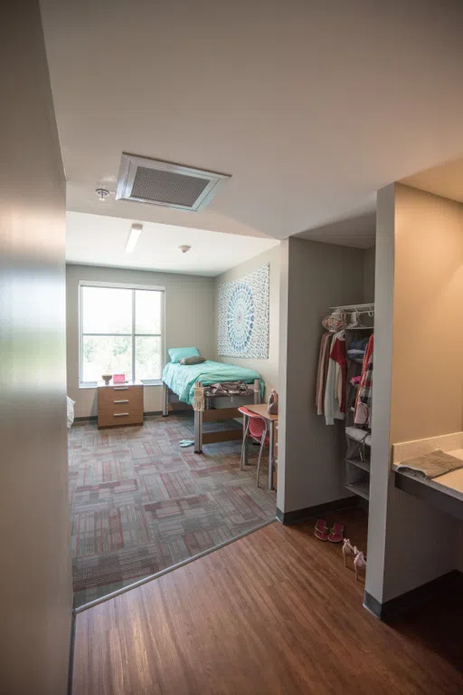 Saints Hall students get a bed, set of drawers, desk and chair, closet, and sink area in their room. The shower and toilet are shared with suitemates. 