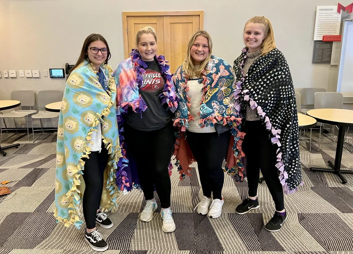 Students create blankets to donate in Buder Commons.