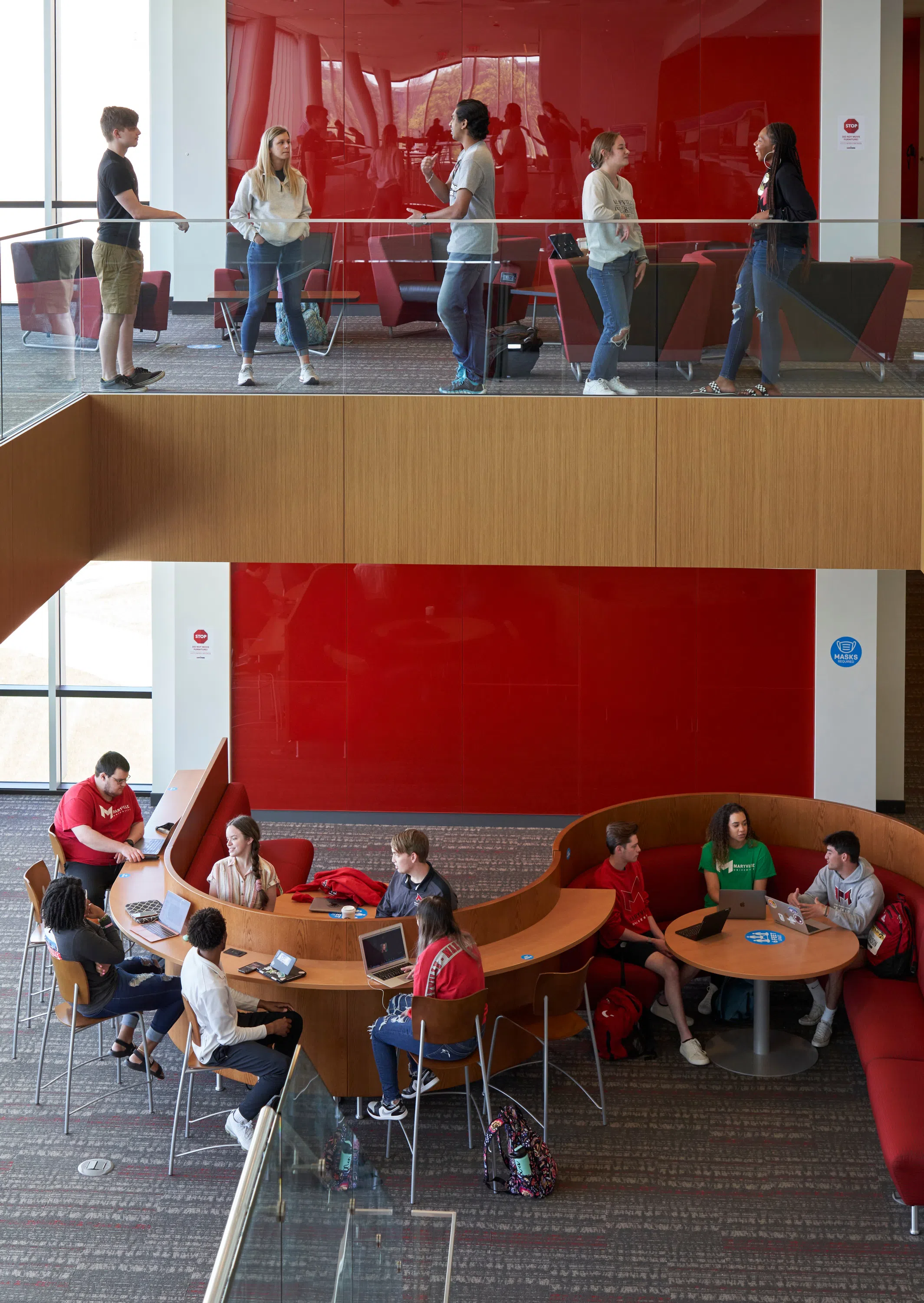 Student chat on two levels of Walker Hall.