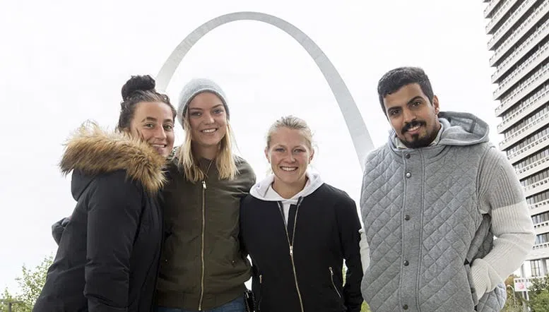 A group of international students explore the STL Arch upon arriving in St. Louis to attend Maryville University. 