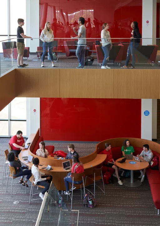 Student chat on two levels of Walker Hall.