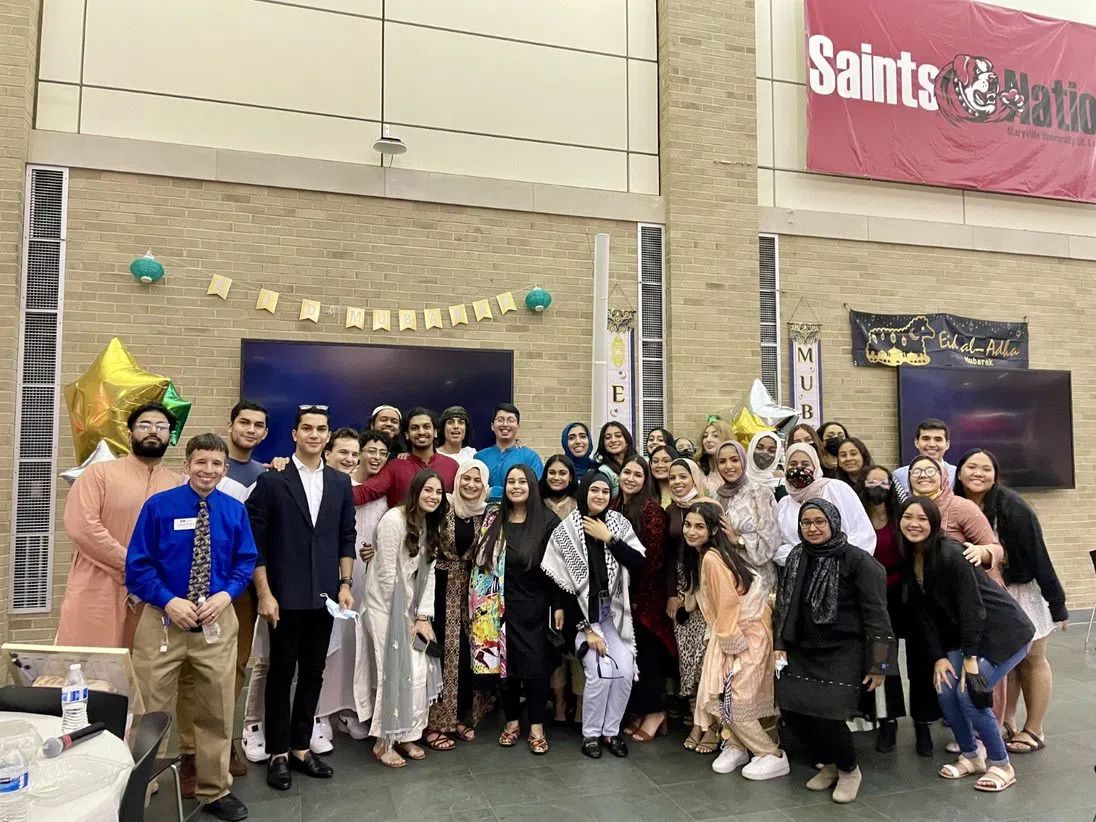 Students pose after participating in the Eid Dinner on campus.