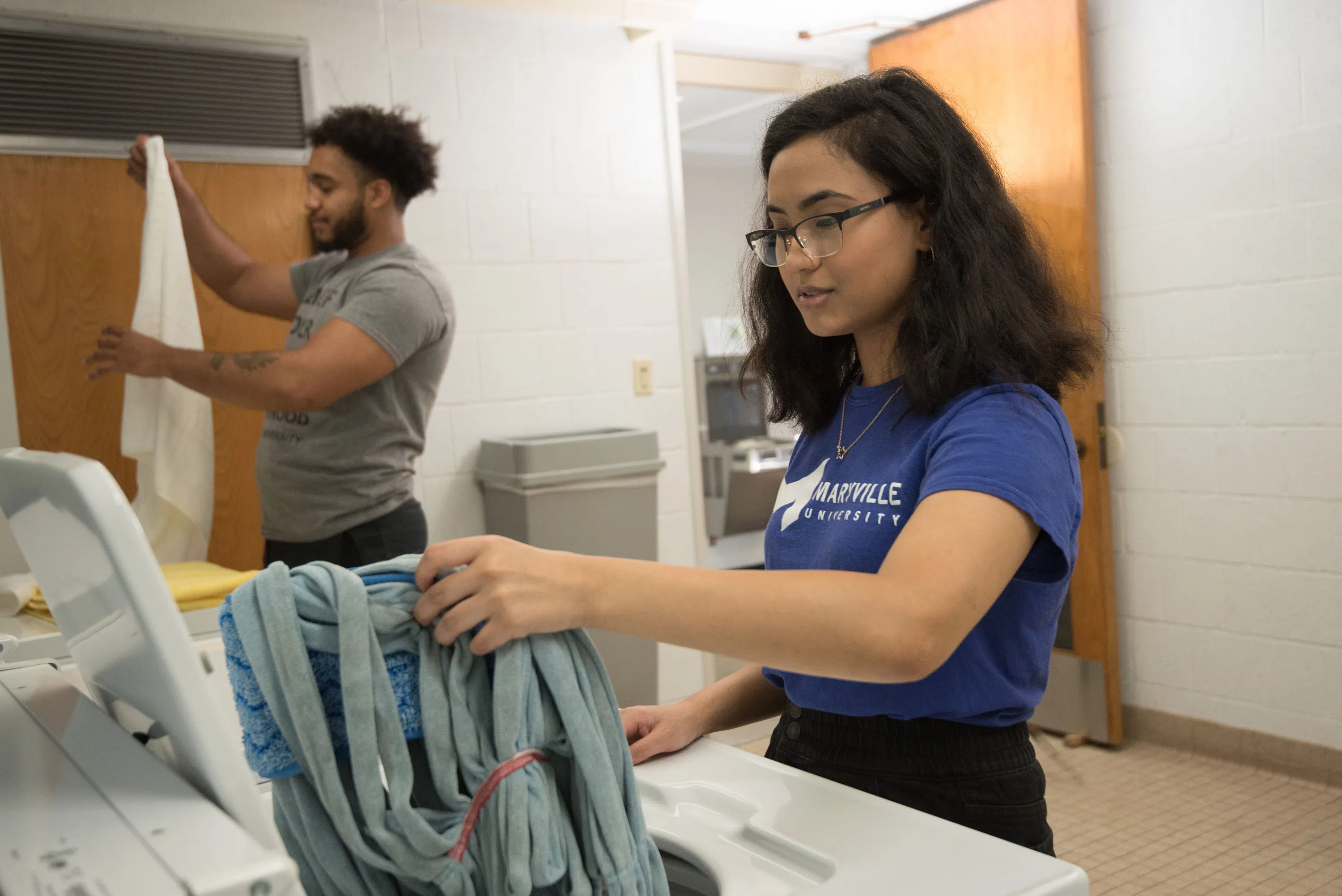 Students do laundry in Mouton Hall. 