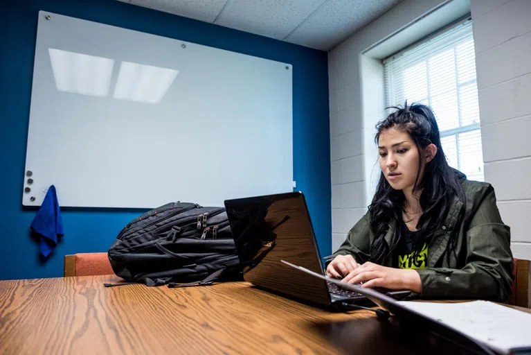 Student works at a laptop 