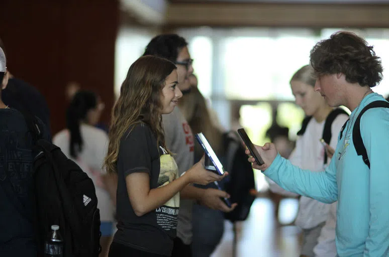 MNU students scanning students into chapel.