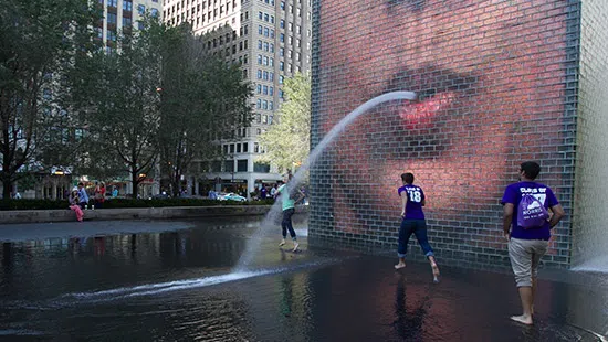 Northwestern students running through fountain in Downtown Chicago