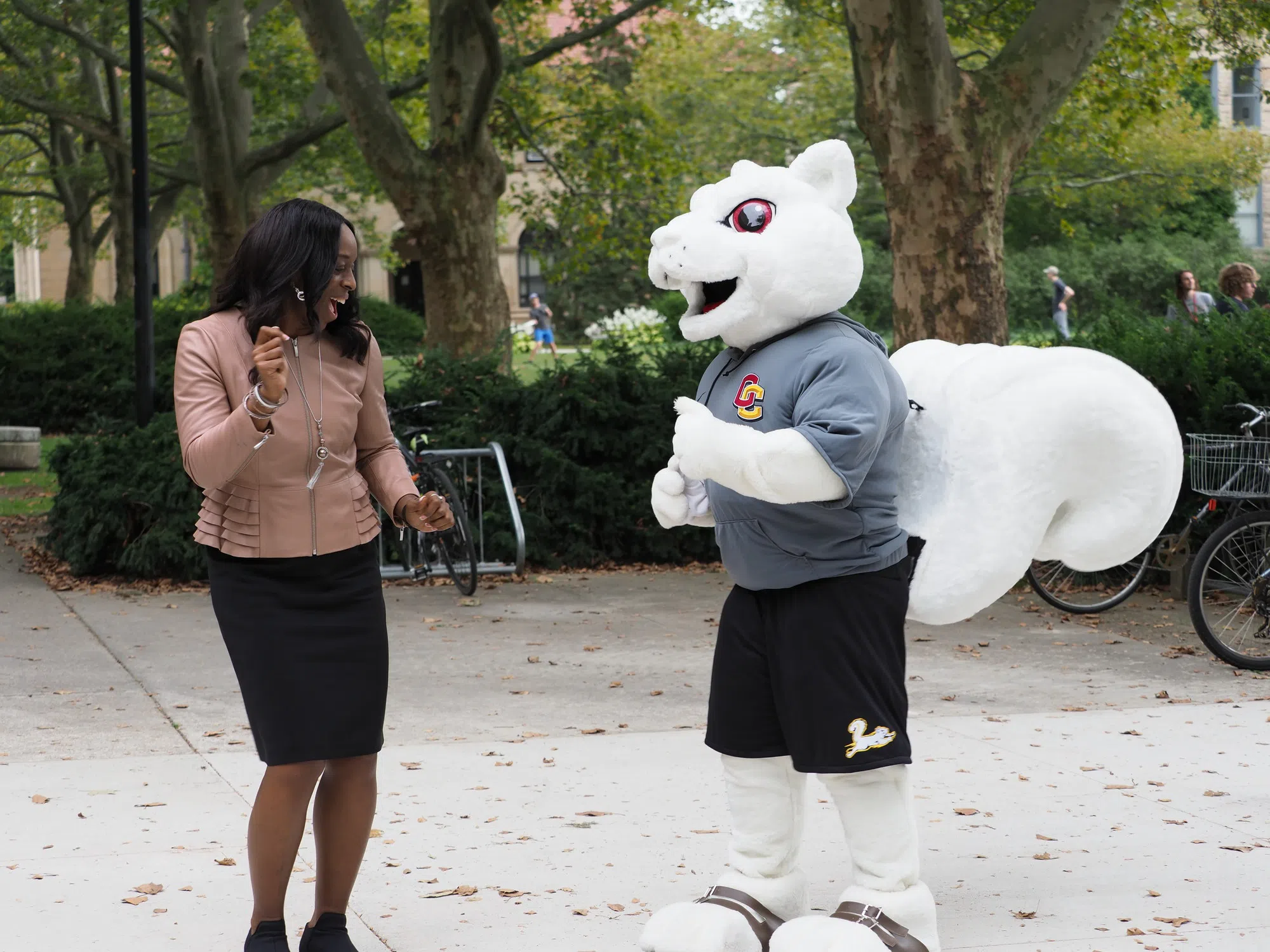 President Ambar and Oberlin's mascot, Yeobie the white squirrel, dance to music.