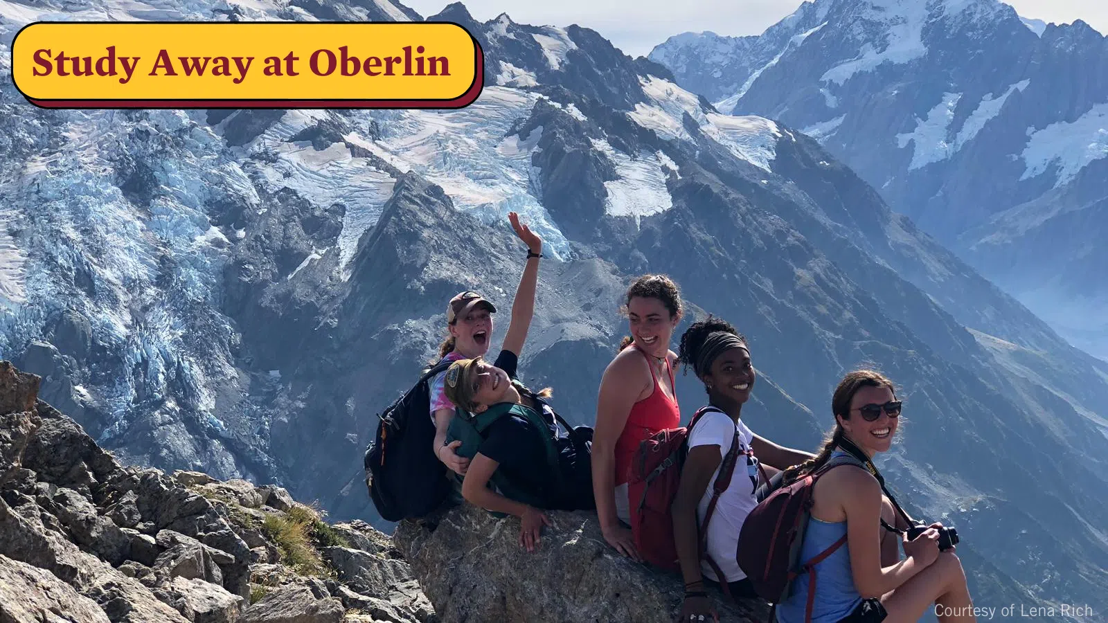 A group of Oberlin students sit atop a mountain while studying away.