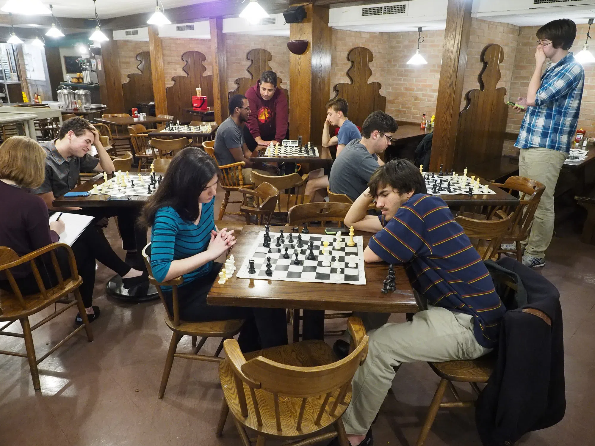 Students sit in the Rathskeller and play chess.