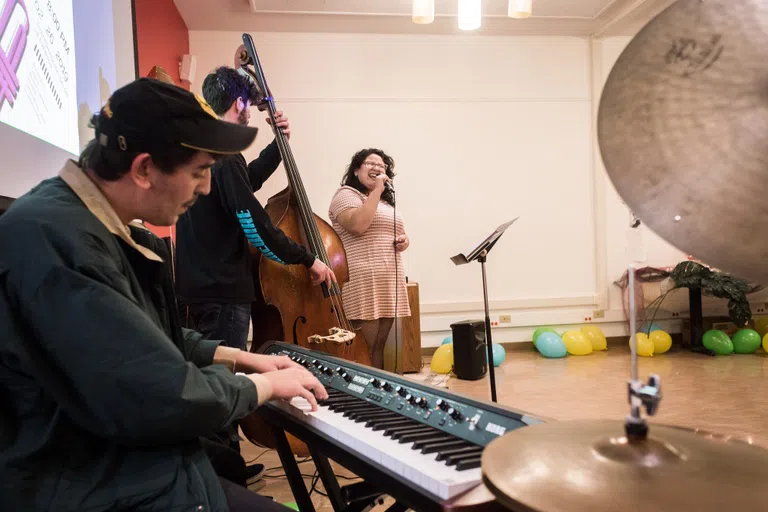 Four musicians perform an indoor concert at Harvey (Spanish) House