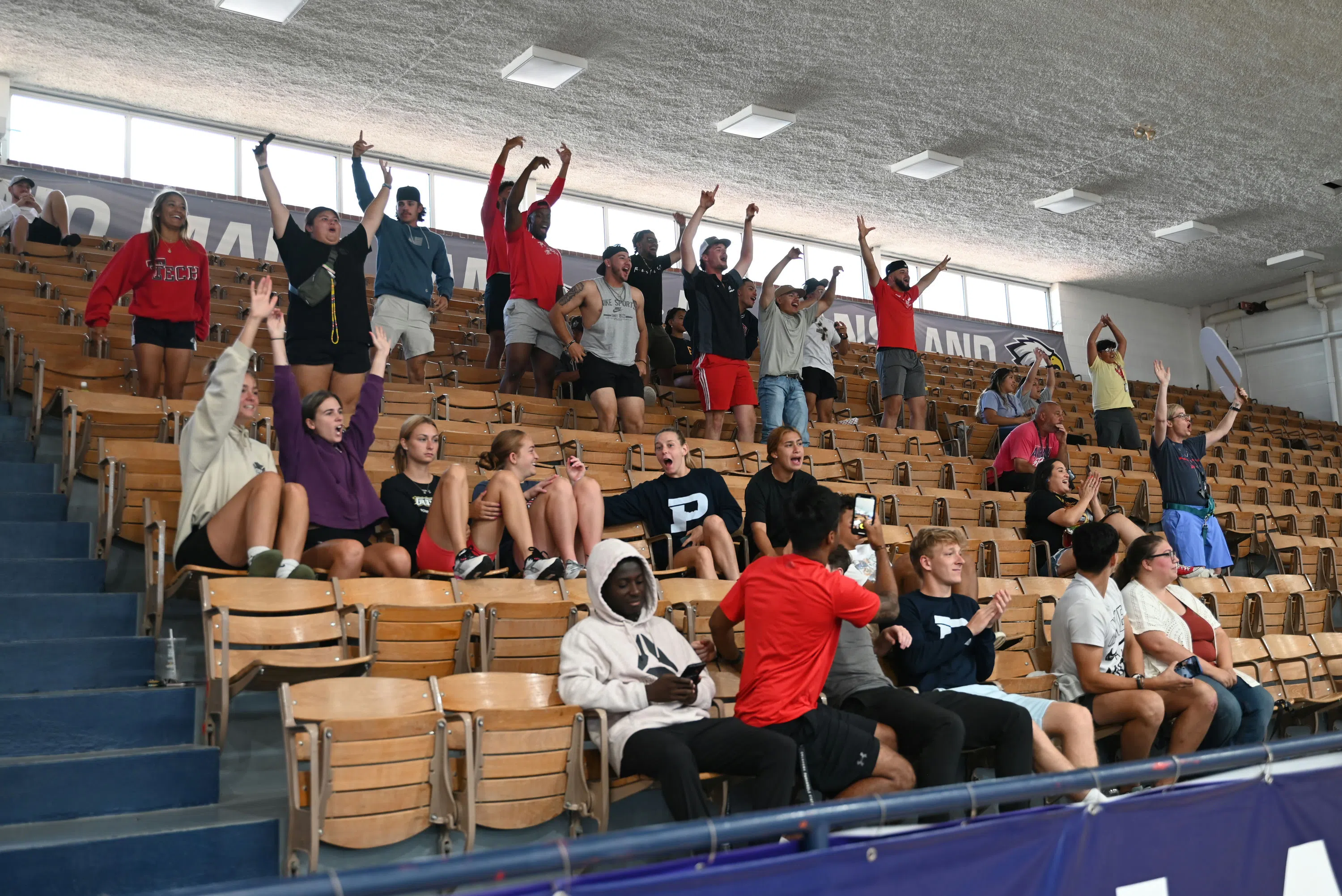 People in the stands cheering inside the Anchor D Arena 