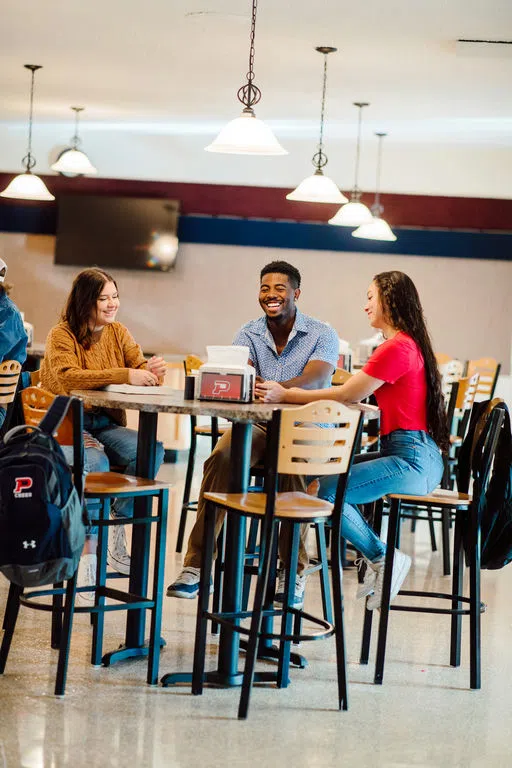 Students sitting around a table talking