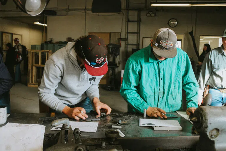 students measuring metal in the Industrial Technology Building