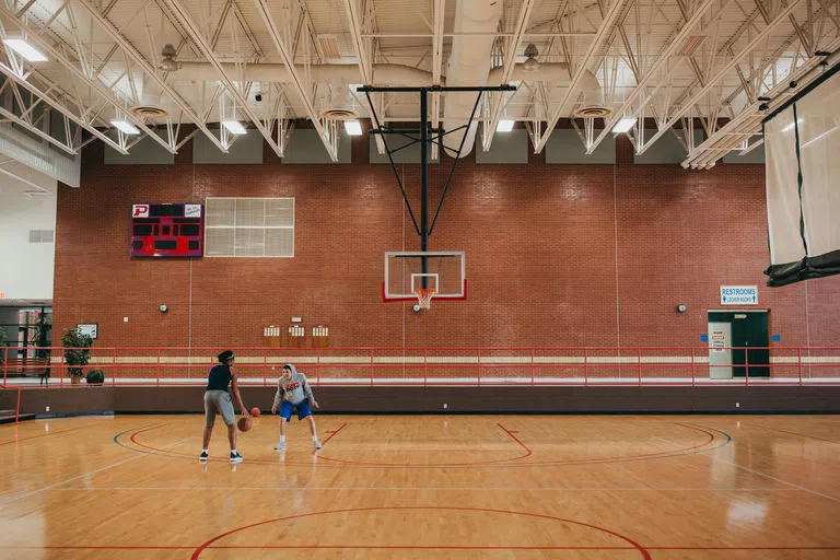 Students playing basketball on court in Noble Center​