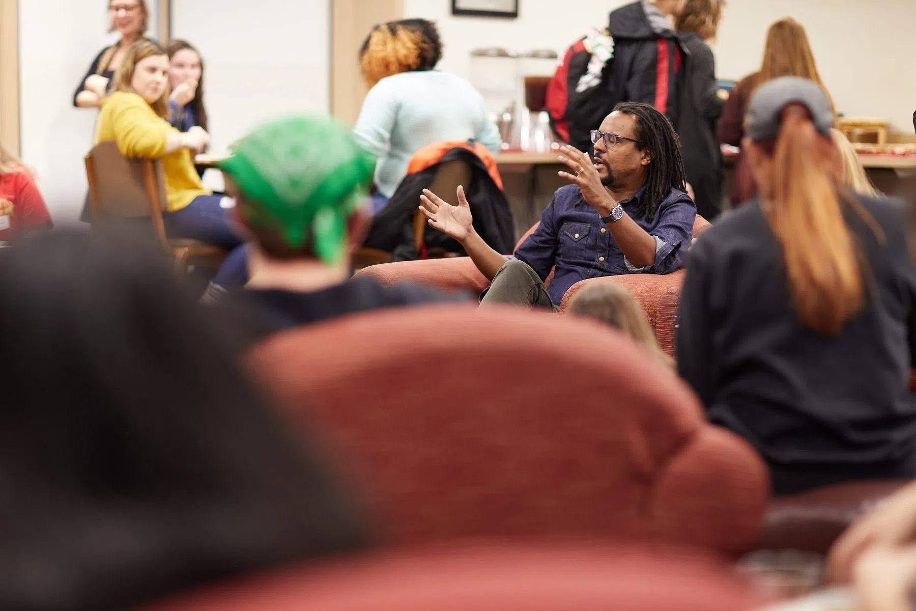 Renowned author Colson Whitehead talks with students during a visit to campus.