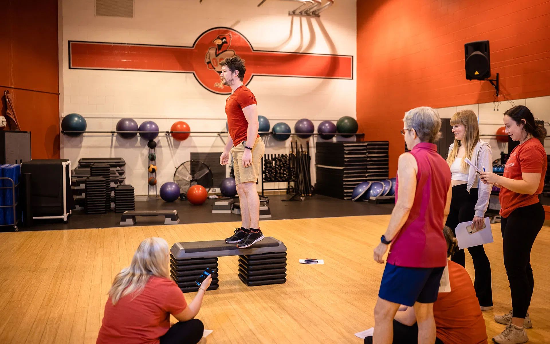 Group of people evaluating a man in the fitness studio