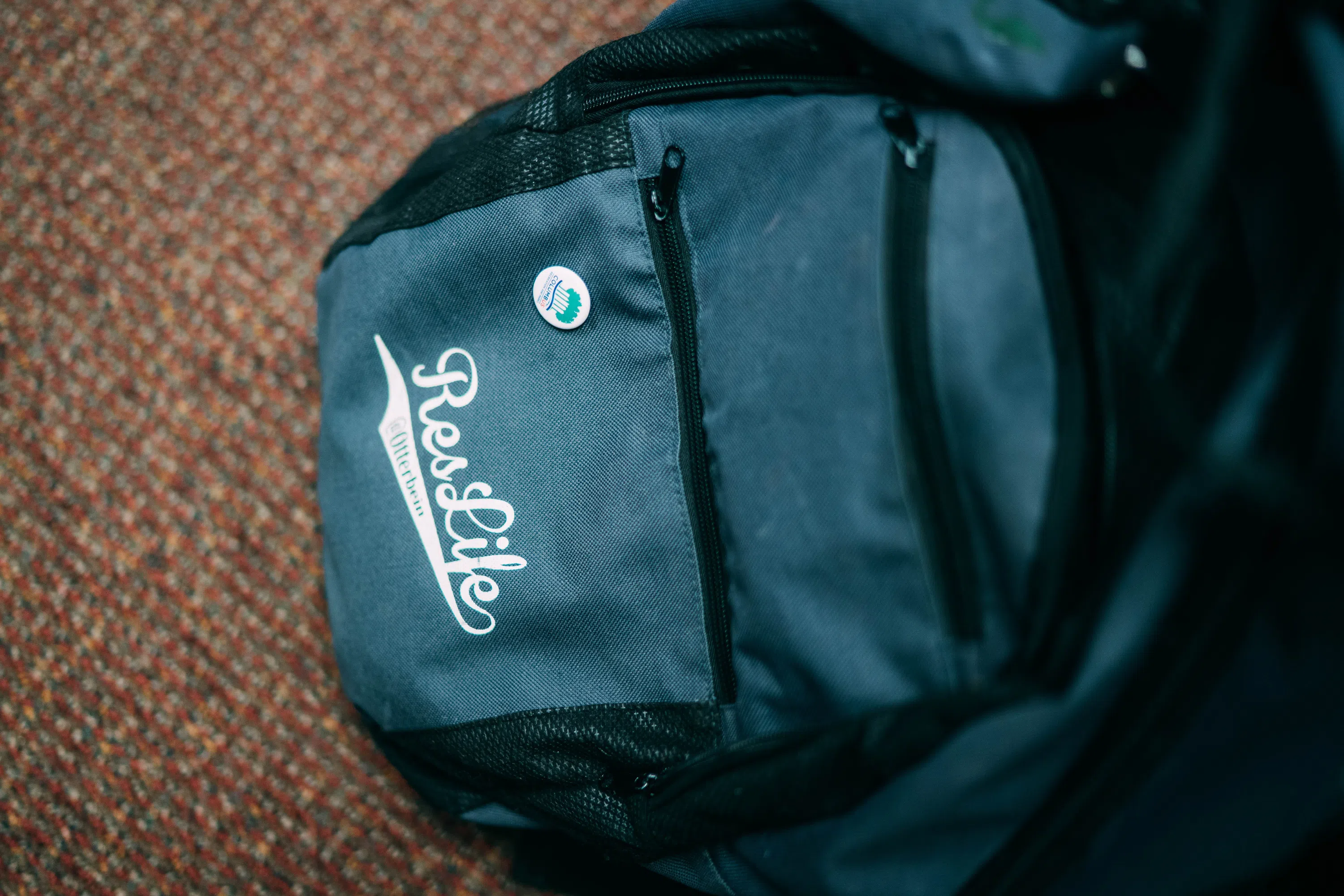 A blue backpack with "ResLife" embroidered on it.