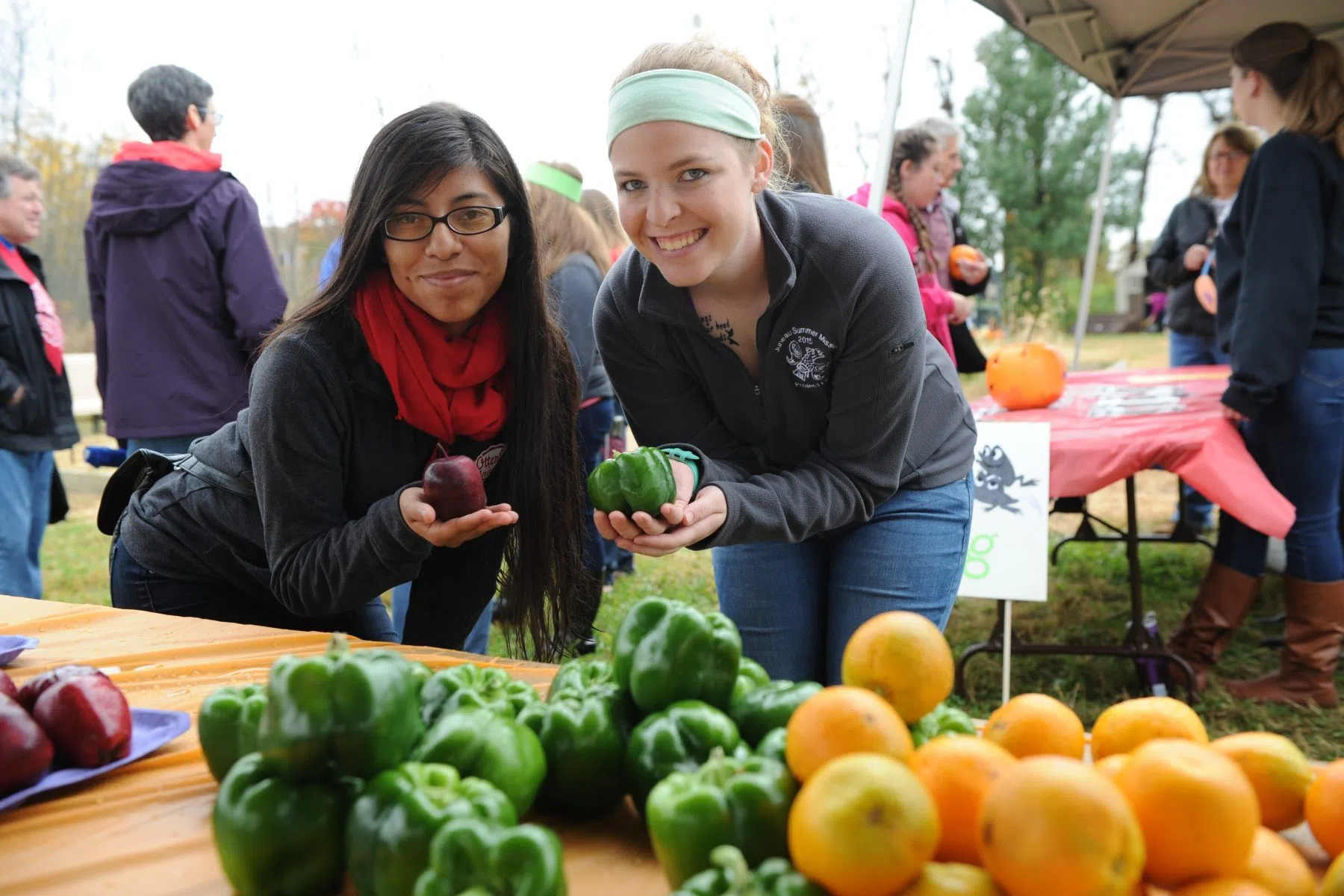 Student volunteers show produce from the Community Garden.
