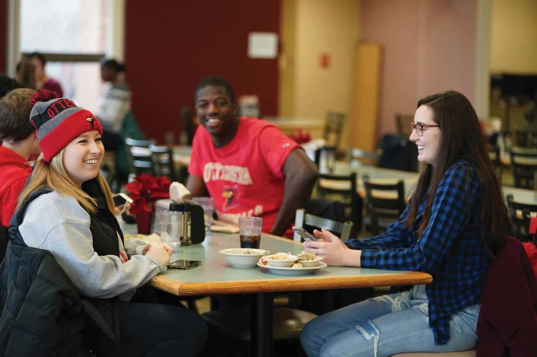 Otterbein students have a fun conversation at one of many tables at the Cardinal's Nest.