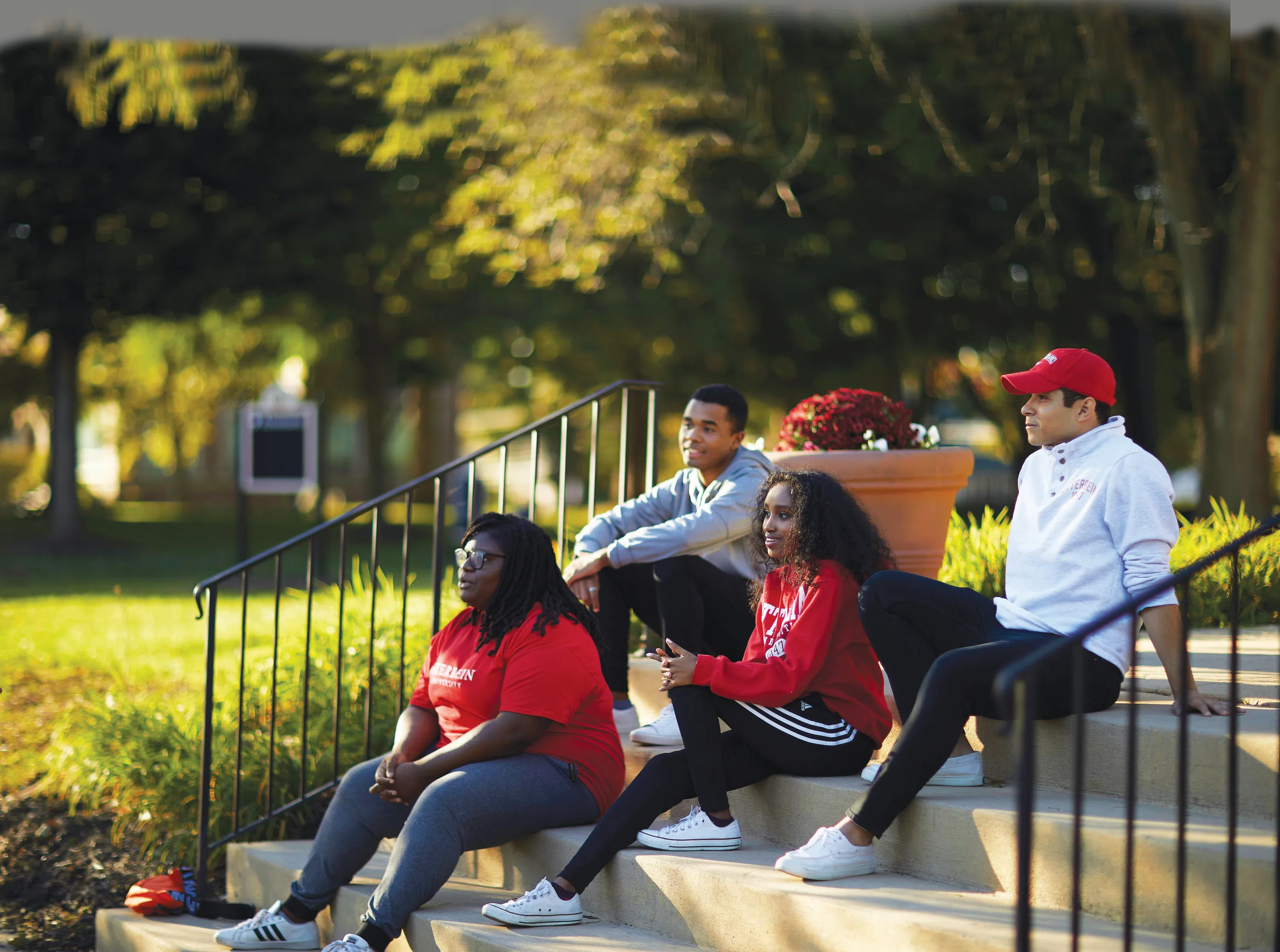 A group of Otterbein students sits on the front stairs of Clippinger Hall.